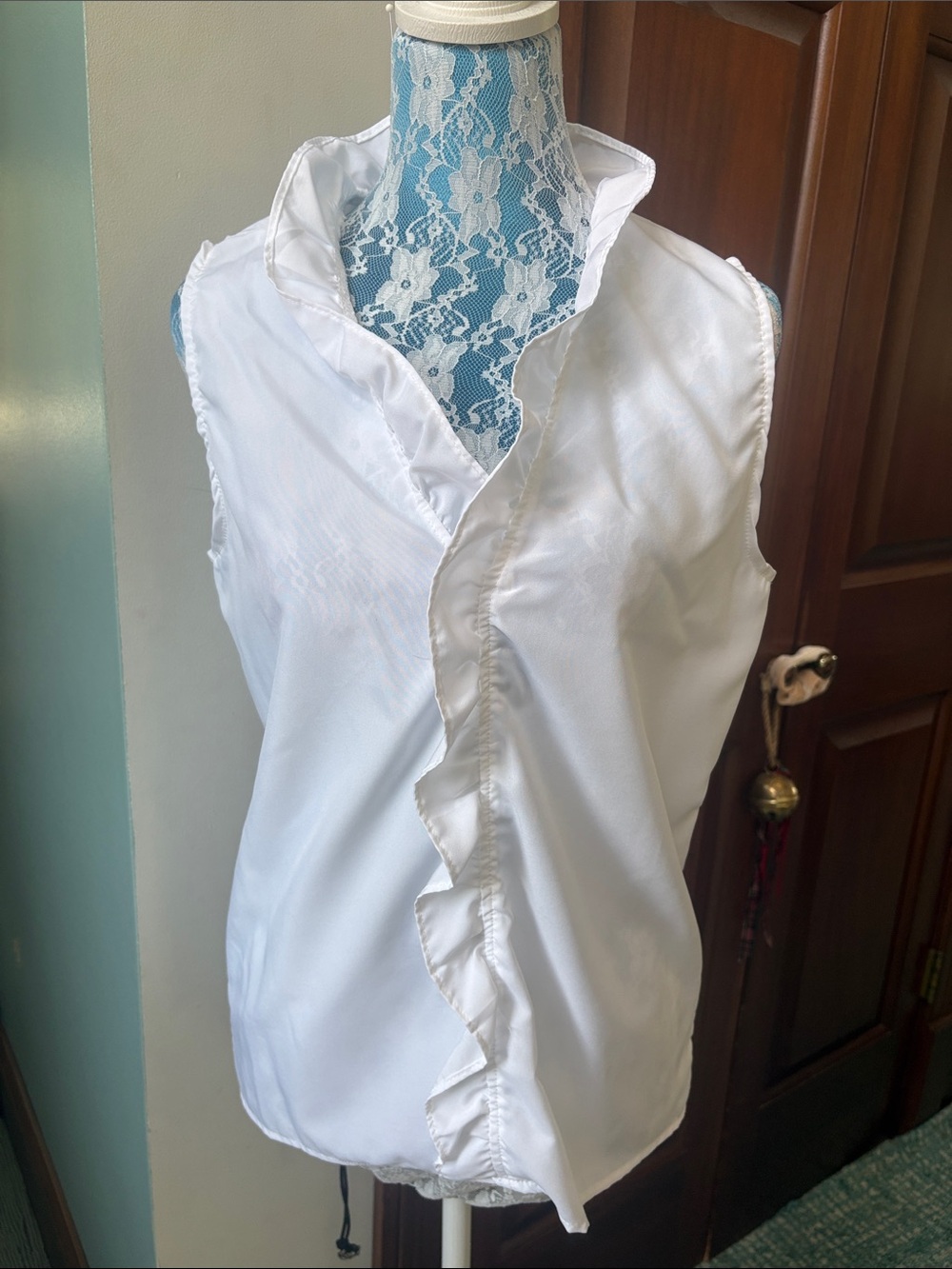 White blouse  V-neck with ruffle front  sleeveless  lightweight, semi sheer NWOT